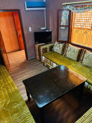 a living room with a couch and a coffee table at Hagounia hotel in Tan-Tan