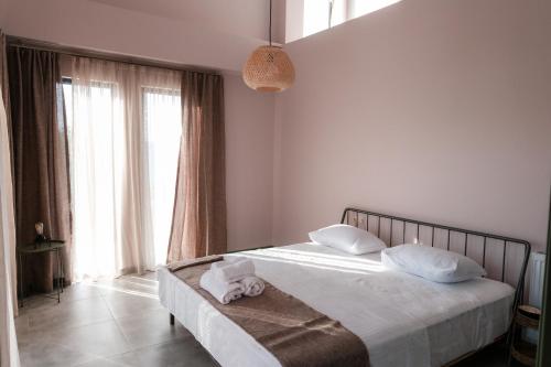 a bedroom with a bed with towels on it at Limonura in Tsikhisdziri