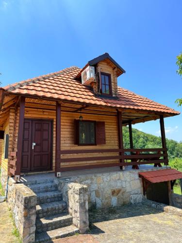 a log cabin with a bench in front of it at Gučevska Idila in Loznica