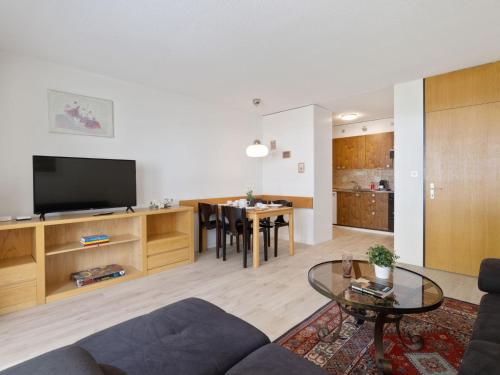 una sala de estar con un sofá y una mesa en Apartment Allod Park Haus C 306 by Interhome, en Davos