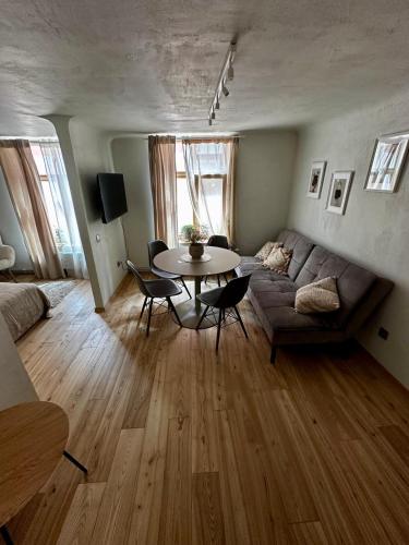 a living room with a couch and a table at Four Seasons Apartments in Tukums