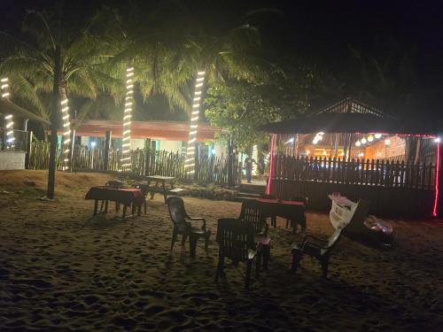 a group of chairs on a beach at night at Hotel Angel Inn Beach in Trincomalee