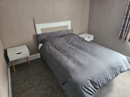 a bedroom with a bed and two night stands at The Bulls Head Hotel in Youlgreave