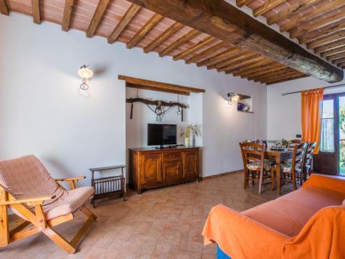 a living room with a couch and a tv and a table at Apartment Stalla by Interhome in Sasso Pisano