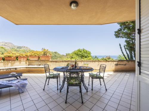 een patio met een tafel en stoelen bij Apartment Cicladi Milos by Interhome in Santa Flavia