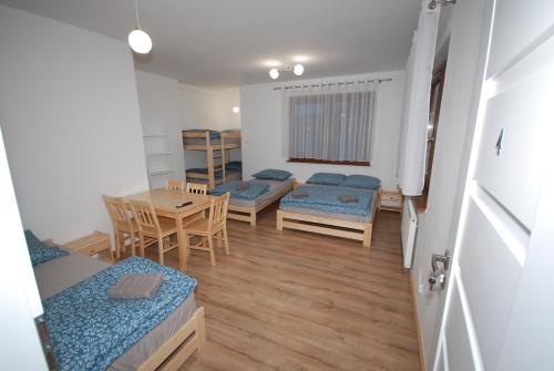 a room with a table and chairs and a dining room at Noclegi Dywity in Dywity