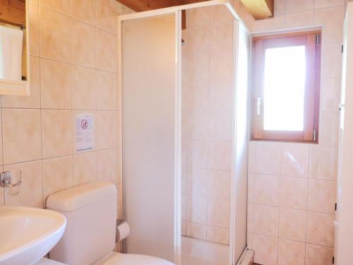 a bathroom with a toilet and a sink and a shower at Holiday Home Rustico Pamela by Interhome in Chiavasco