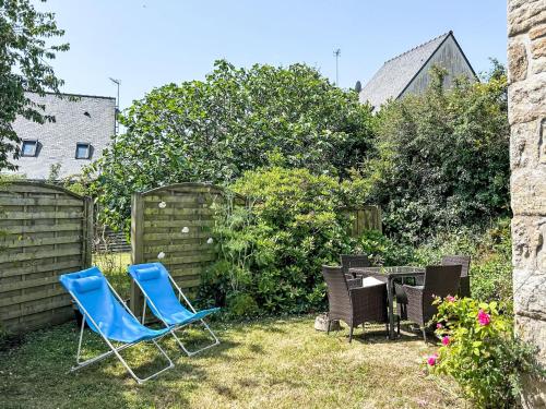 Dos sillas azules y una parrilla en el patio trasero. en Holiday Home Courdiec by Interhome, en Carnac