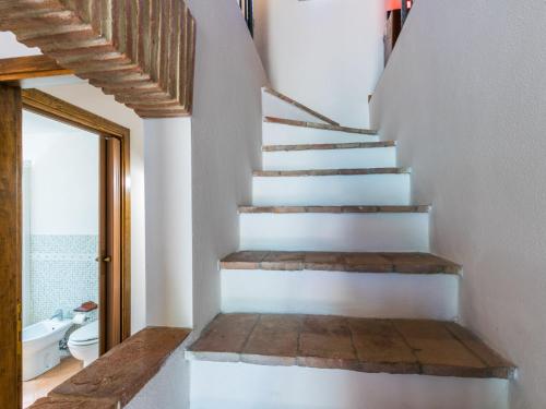 a staircase in a bathroom with a toilet and a sink at Apartment Fienile by Interhome in Sasso Pisano