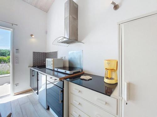 une cuisine avec un comptoir noir et une fenêtre dans l'établissement Holiday Home Les Hauts du Parc by Interhome, à Saint-Palais-sur-Mer