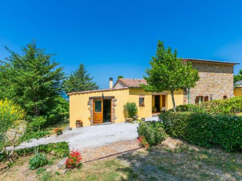 a small yellow house with a yard at Apartment Fienile by Interhome in Sasso Pisano