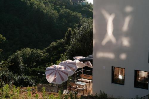 a group of umbrellas and chairs and a building at Limonura in Tsikhisdziri
