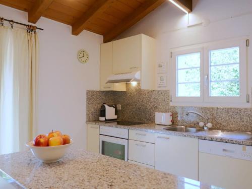 a kitchen with a bowl of fruit on a counter at Holiday Home Felice by Interhome in Anvéuda