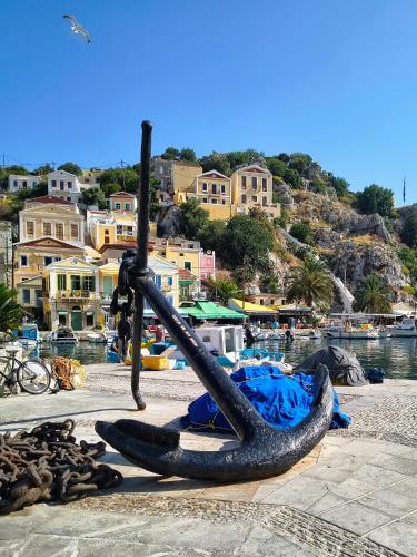 a sculpture of an anchor on a beach at Lirenou Scala Vista in Symi