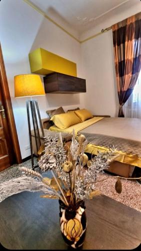 a bedroom with a bed and a plant in a vase at Luxury Penthouse 50m from the Sea, near the Center in Savona