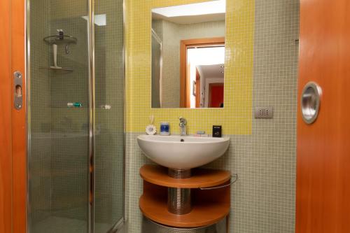 a bathroom with a sink and a glass shower at Appartamento Margherita in Venice