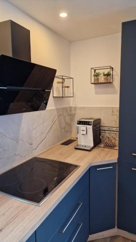 a kitchen with a counter with a stove top oven at LE MUGEL cocooning SPA et proche calanques de Cassis in Carnoux