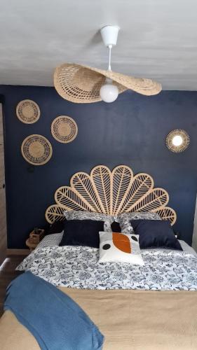 a bedroom with a bed with a fan on it at LE MUGEL cocooning SPA et proche calanques de Cassis in Carnoux
