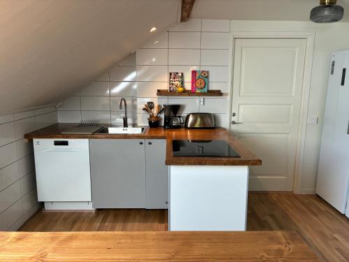 a kitchen with white cabinets and a sink at La Casa Klippan in Rockneby