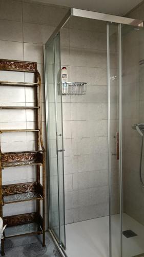 a shower with a glass door in a bathroom at Villa Ruperta in A Guarda