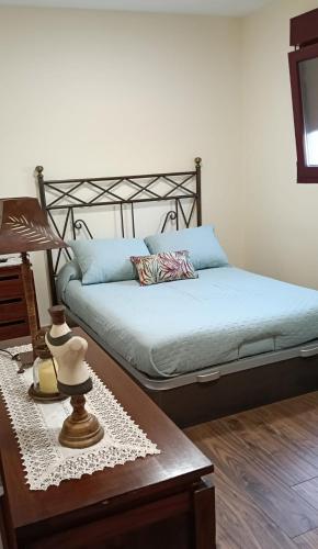 a bedroom with a bed and a table with a table sidx sidx at Villa Ruperta in A Guarda