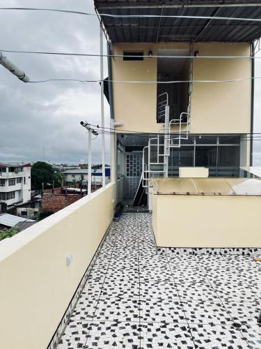 a balcony of a building with a tiled floor at Departamento Céntrico in Pucallpa