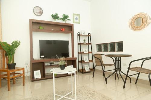 a living room with a tv and a table and chairs at Departamento Céntrico in Pucallpa