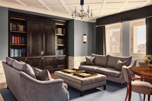 a living room with two chairs and a couch and a table at The Connaught, Maybourne in London