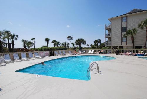 a large swimming pool with chairs and people in it at Breakers 207 in Hilton Head Island
