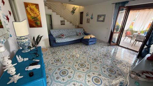 a living room with a blue couch and a blue table at Luxury Villa Diamante in Casa del Lago