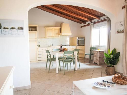 a kitchen and dining room with a table and chairs at Apartment Palau by Interhome in Arzachena