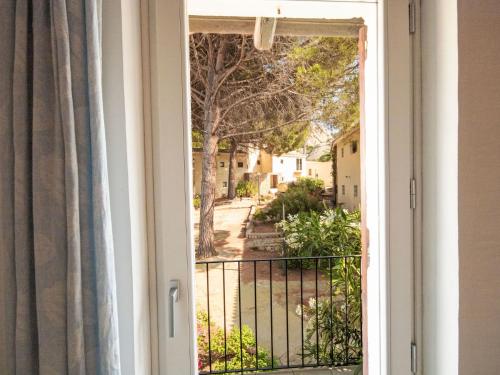 a window with a view of a street at Apartment Palau by Interhome in Arzachena