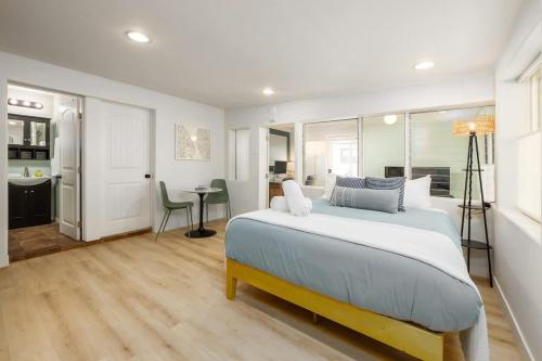 a bedroom with a large bed and a dining room at Studio In Carlsbad Village in Carlsbad