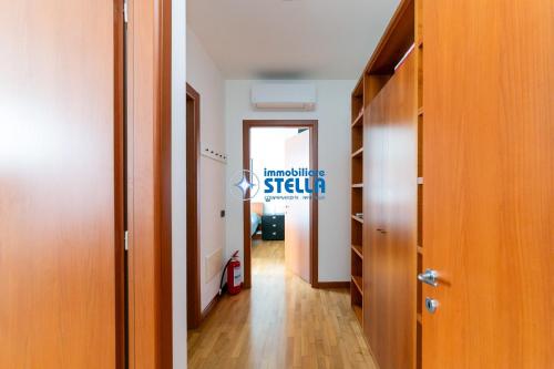 a corridor of a room with a door and a hallway at Archimede in Lido di Jesolo