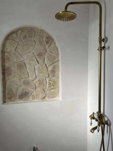 a light on a wall with a stone wall at Villa Eden Djerba in Djerba