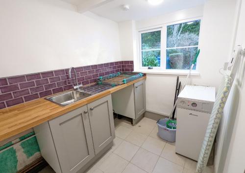 a kitchen with a sink and a counter top at Skelwith Fold Cottage No.3 in Elterwater
