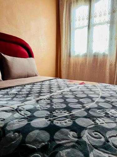 a bedroom with a large bed with a window at Hagounia hotel in Tan-Tan
