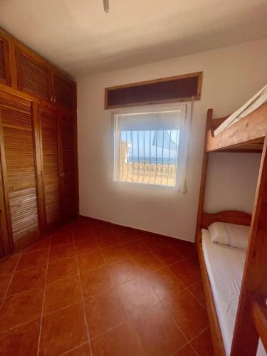 a room with two bunk beds and a window at Sea View & Comfort in Oued Laou in Oued Laou