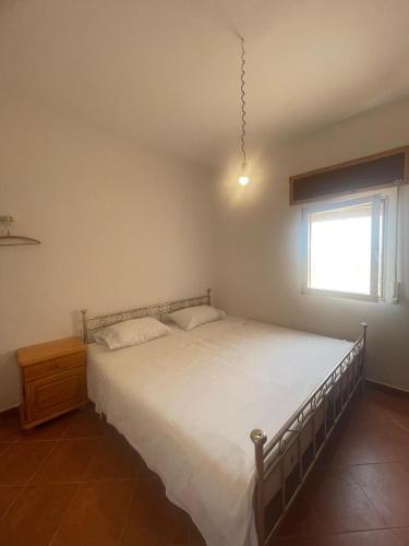 a bedroom with a large bed and a window at Sea View & Comfort in Oued Laou in Oued Laou