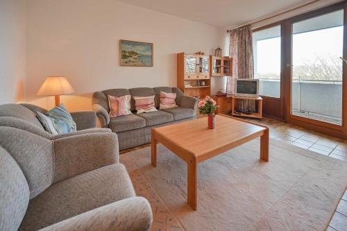 a living room with two couches and a coffee table at FeWo Zeidler Nr42 Sol Mare in Kellenhusen