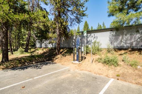 a parking lot with a parking meter next to a fence at Woodpecker Lookout in Sunriver