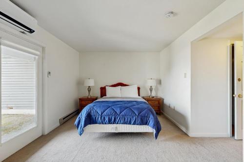 a white bedroom with a bed and a window at Birch Tree II in Bar Harbor