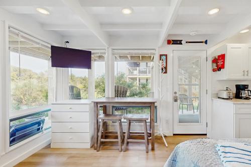 a kitchen with a table and chairs in a bedroom at Ships Ahoy in Truro