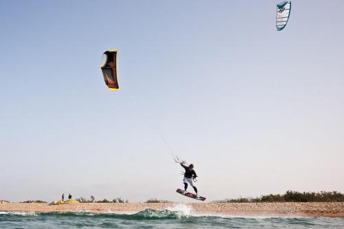 a man flying a kite on the beach at Homeliday RELAX in Caldana