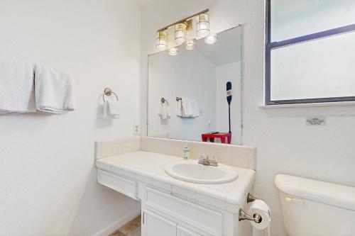a white bathroom with a sink and a mirror at Crestwood Cove in Kingsland