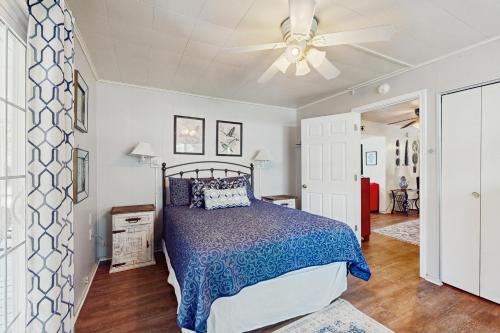 a bedroom with a bed and a ceiling fan at Grace Cottage in Kingsland