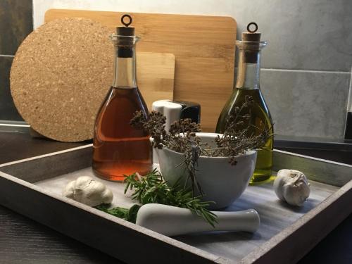 a tray with two bottles of wine and a bowl of herbs at Casa di Lavanda in Hvar