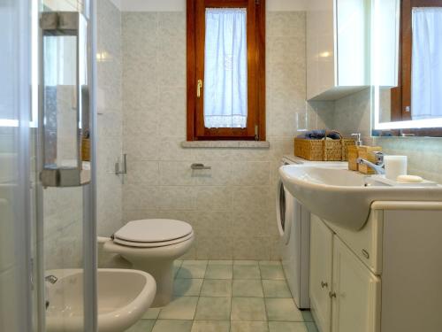 a bathroom with a toilet and a sink at Apartment La casa dei Cestini by Interhome in Agrustos