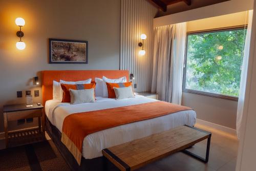 a bedroom with a large bed and a window at Iguazu Jungle Lodge in Puerto Iguazú