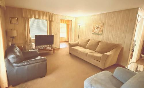 a living room with a couch and a chair at Riviera Haven, 10 Minutes from the Beach, Coastal Town, Quaint & Comfy in Riviera Beach